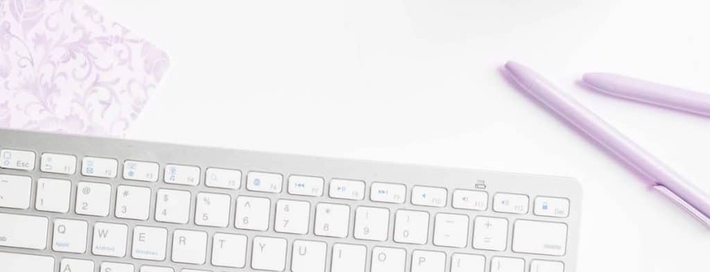 white keyboard with pink flower and pink pens