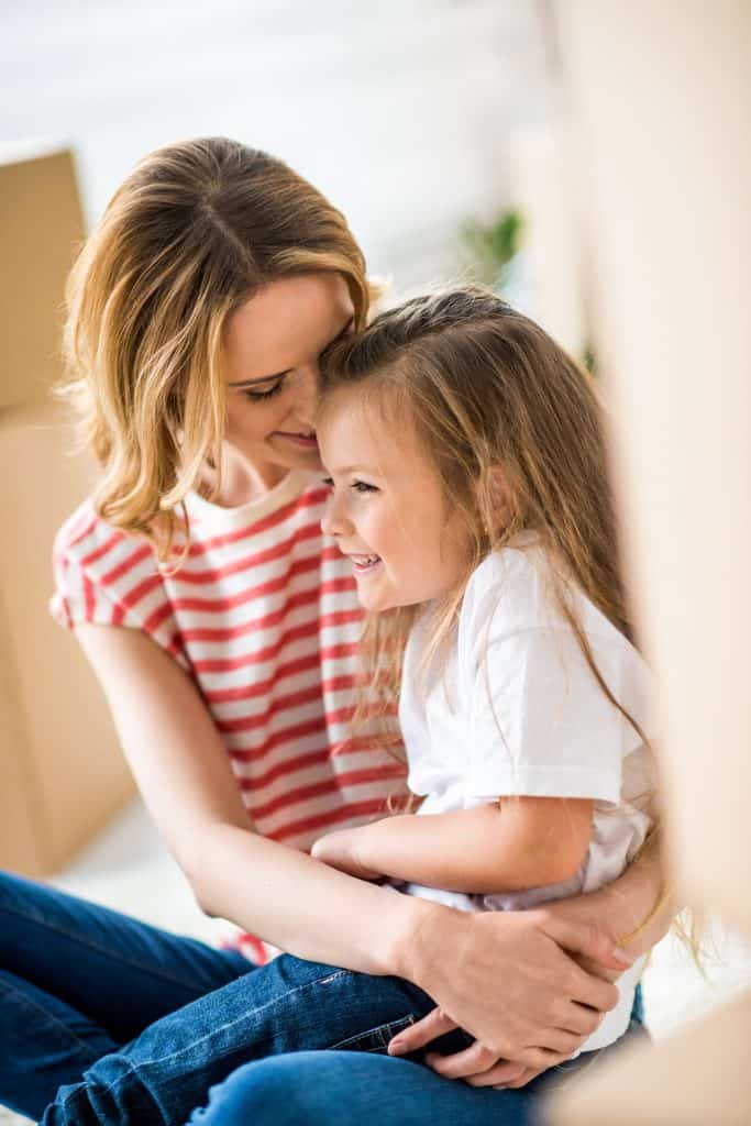 Image of woman snuggling daugther