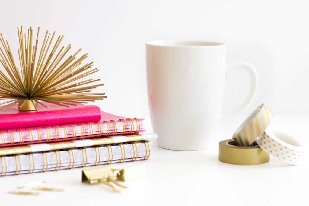 Coffee mug with journals and pen