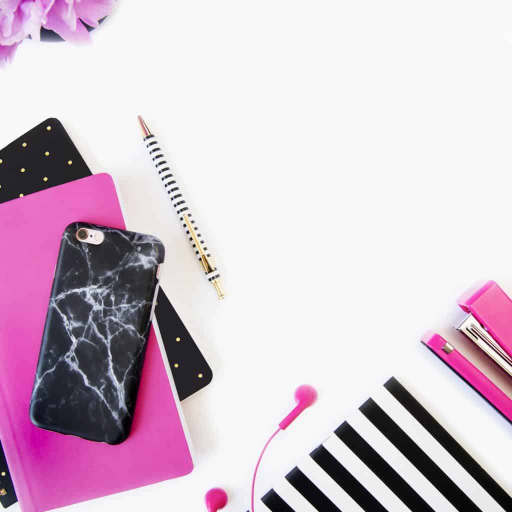 journals, smartphone, pen, earpiece