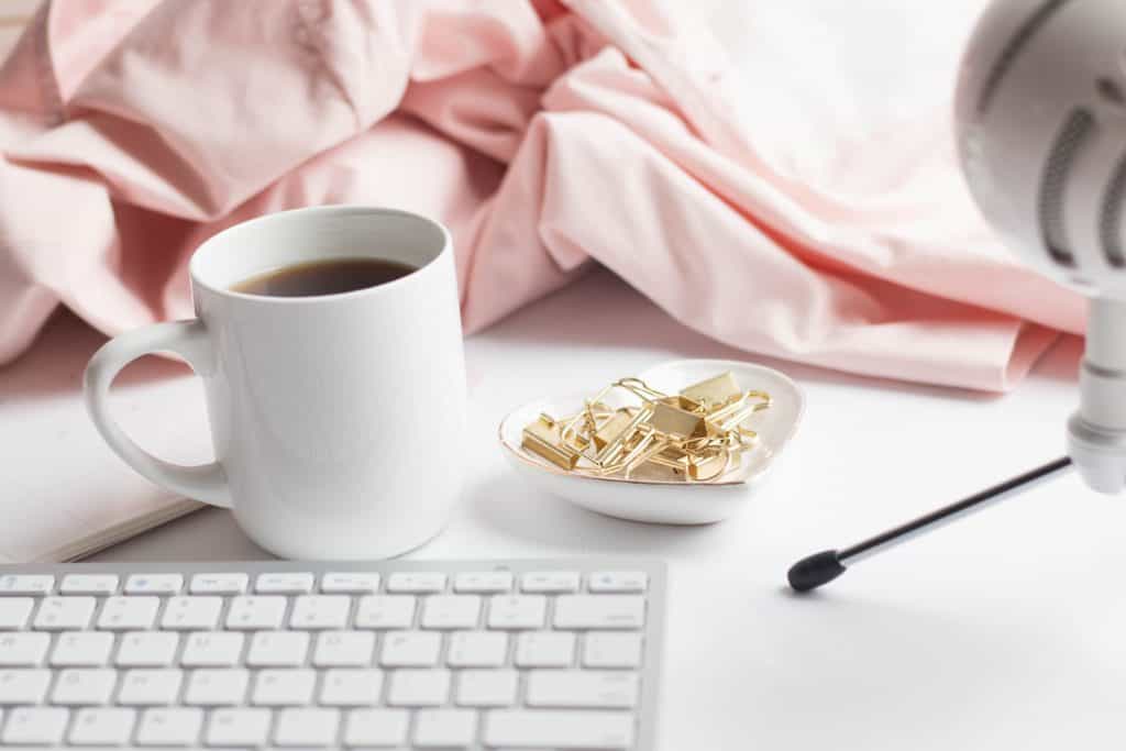 Keyboard, cup of coffee, clips and blanket