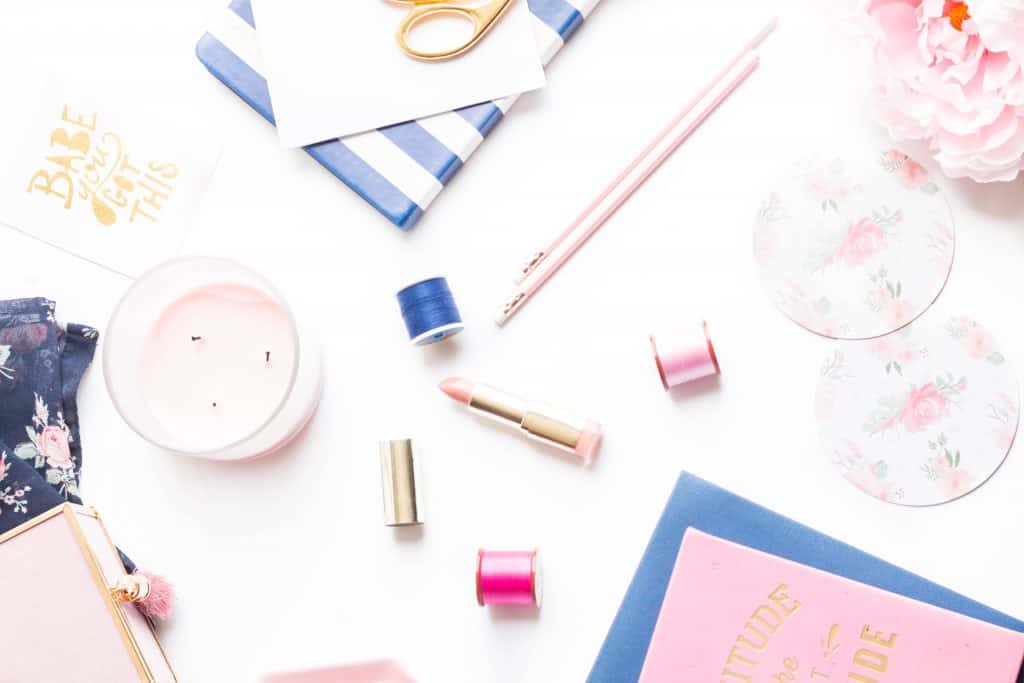Flatlay image with candle, clips, pen, notebooks