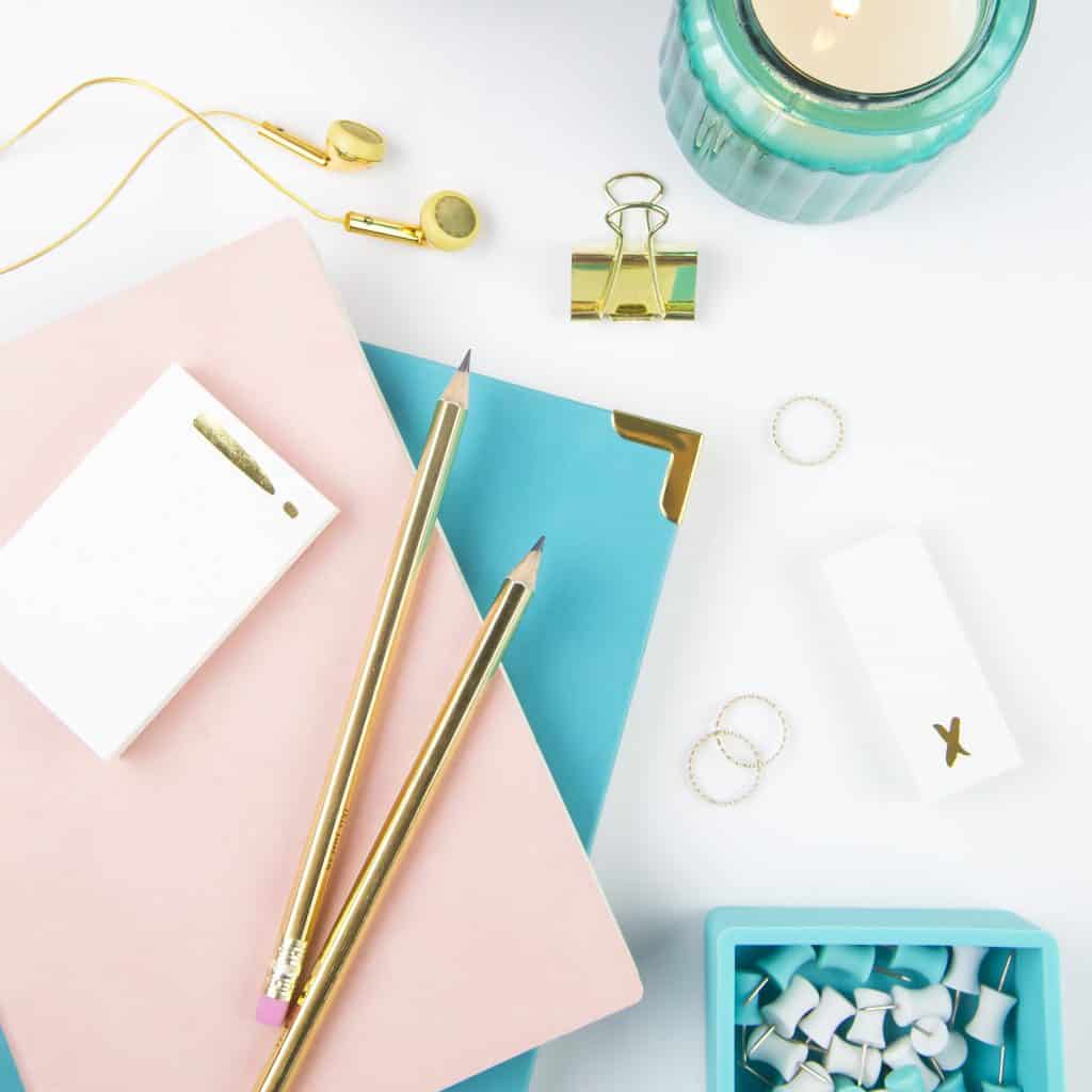 Journals, pencils, candle, smartphone and clips