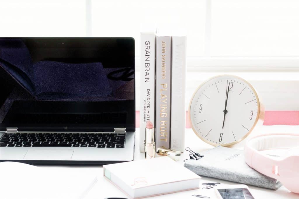 Laptop, clock, notepad