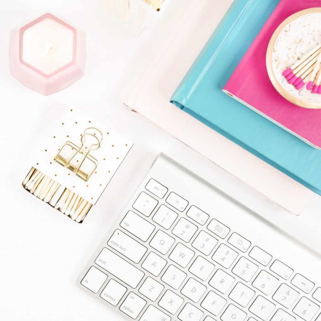 Journals, keyboard, candle, clips and matches in tray