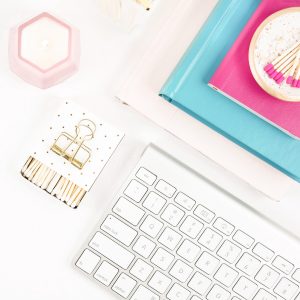 Journals, keyboard, candle, clips and matches in tray