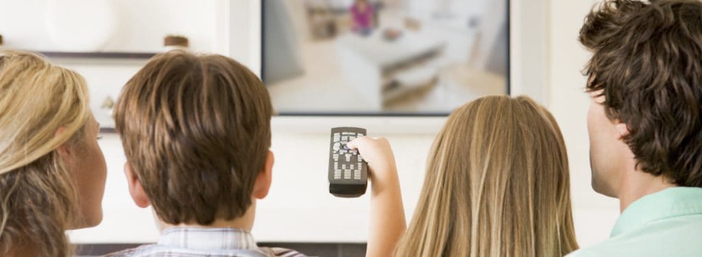 family on the couch watching videos on tv