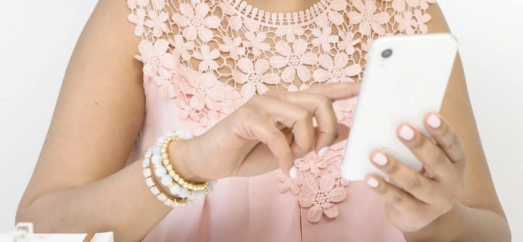 dressed up woman using a smartphone