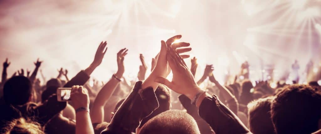 crowd enjoying a concert used as the featured image in the post on free concert tickets