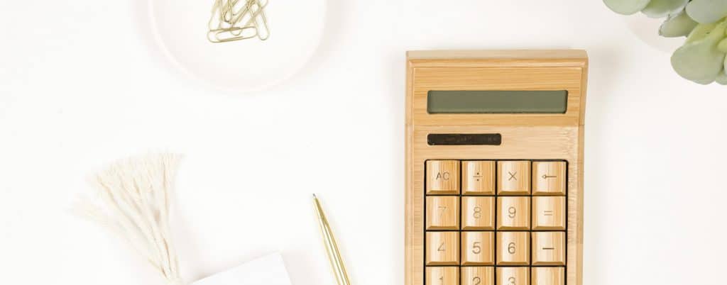 calculator with pen and paperclips