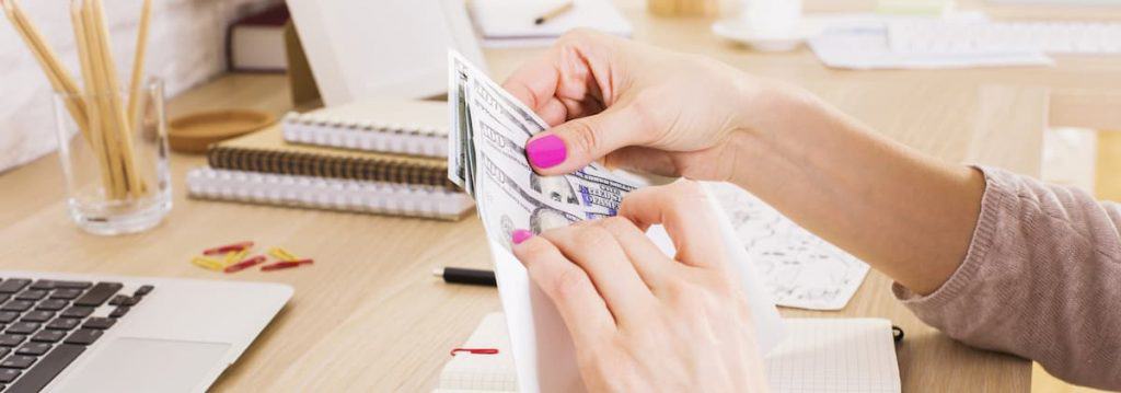 Woman putting money in an envelope