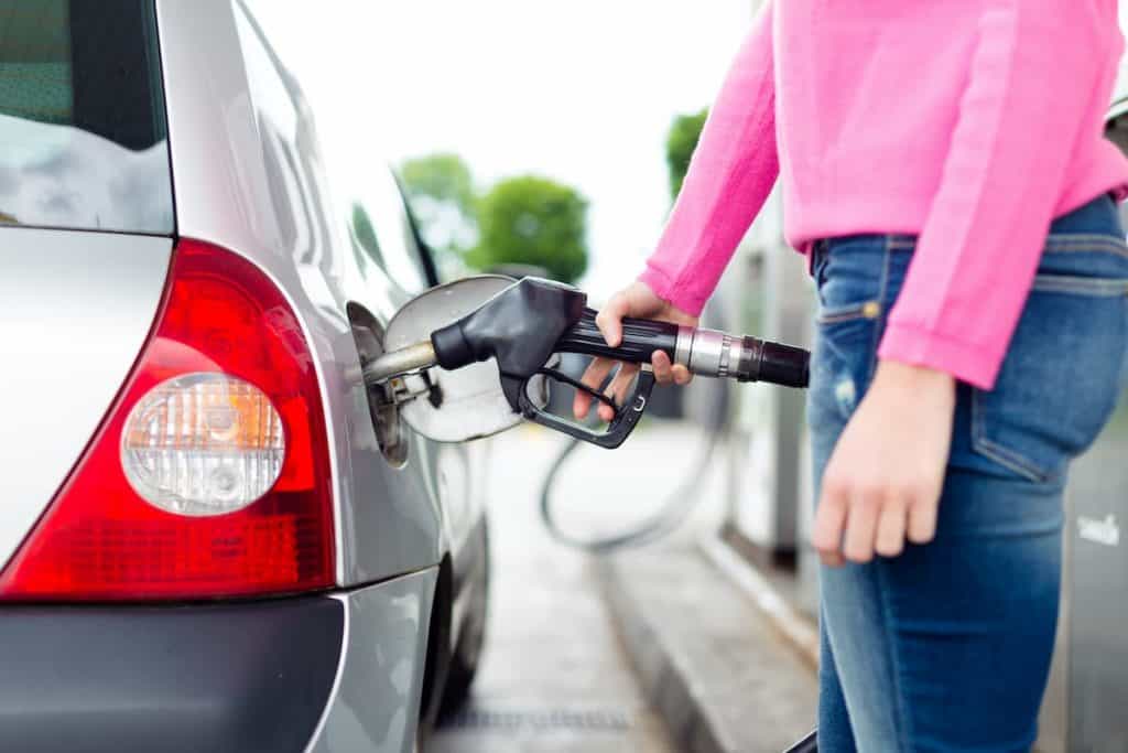 Woman pumping gas at a gas station