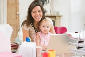 Woman with child working on her home business